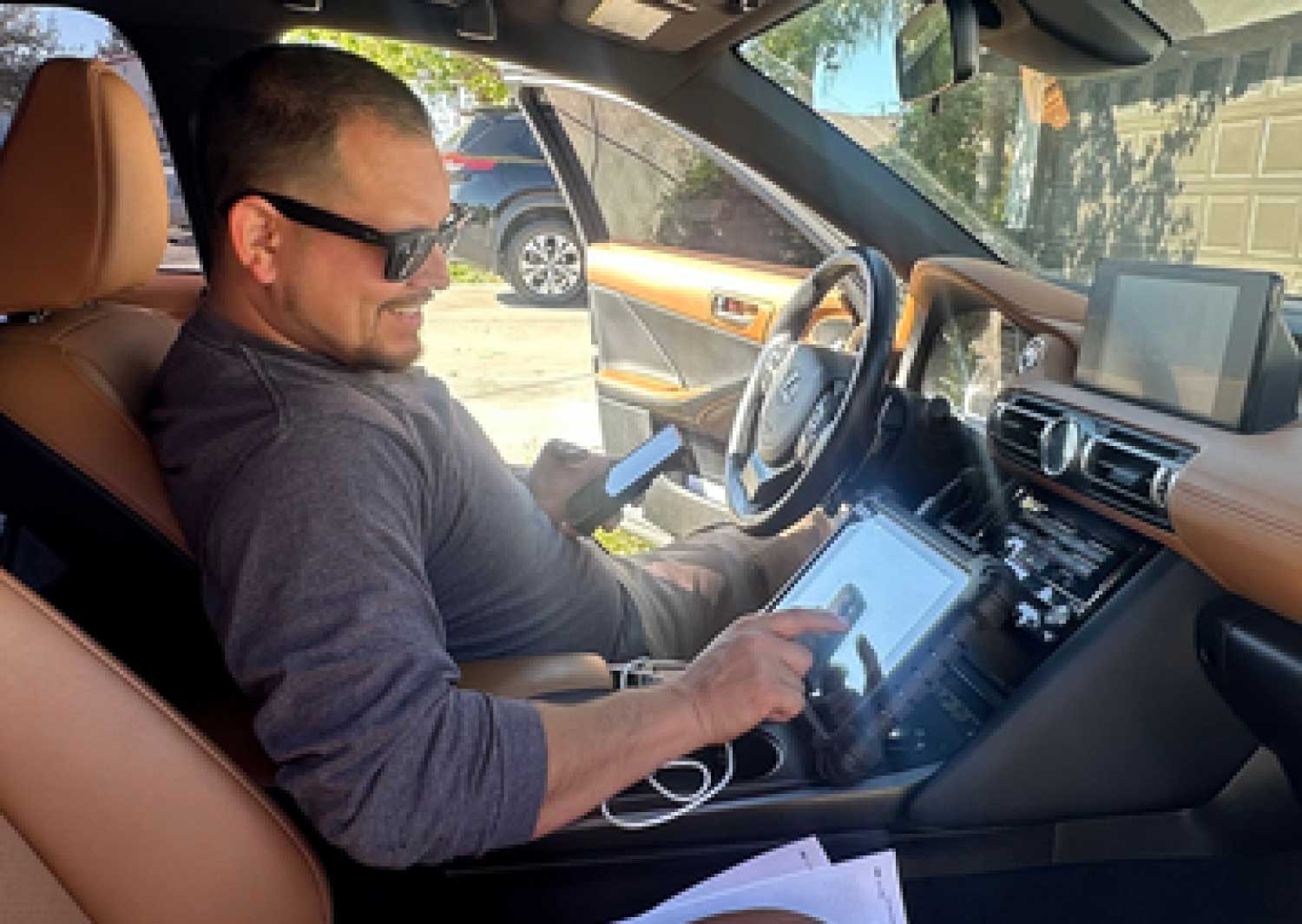 Windshield-Calibration-Image A Laptop with blank white screen in the car engine compartment of an automobile in a car repair garage , Car maintenance service concept